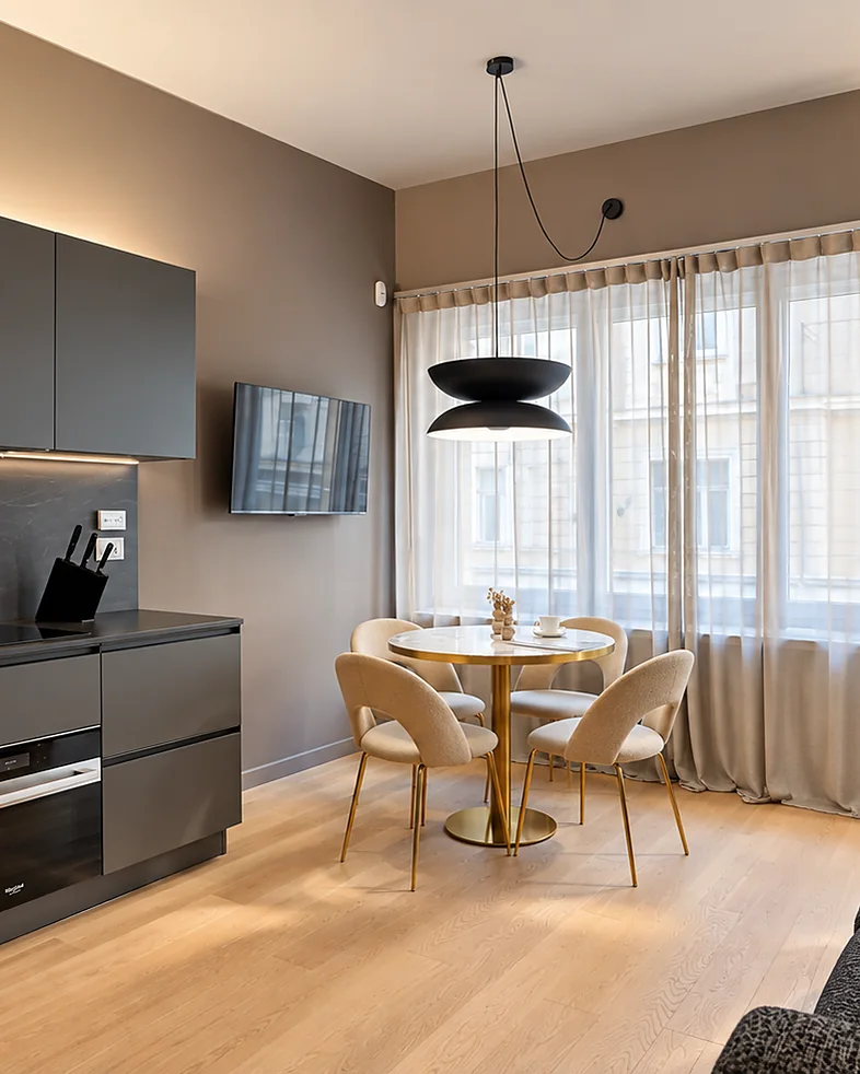 Kitchen with a round table, velvet chairs and tall curtained windows: Terra Suite, Turin
