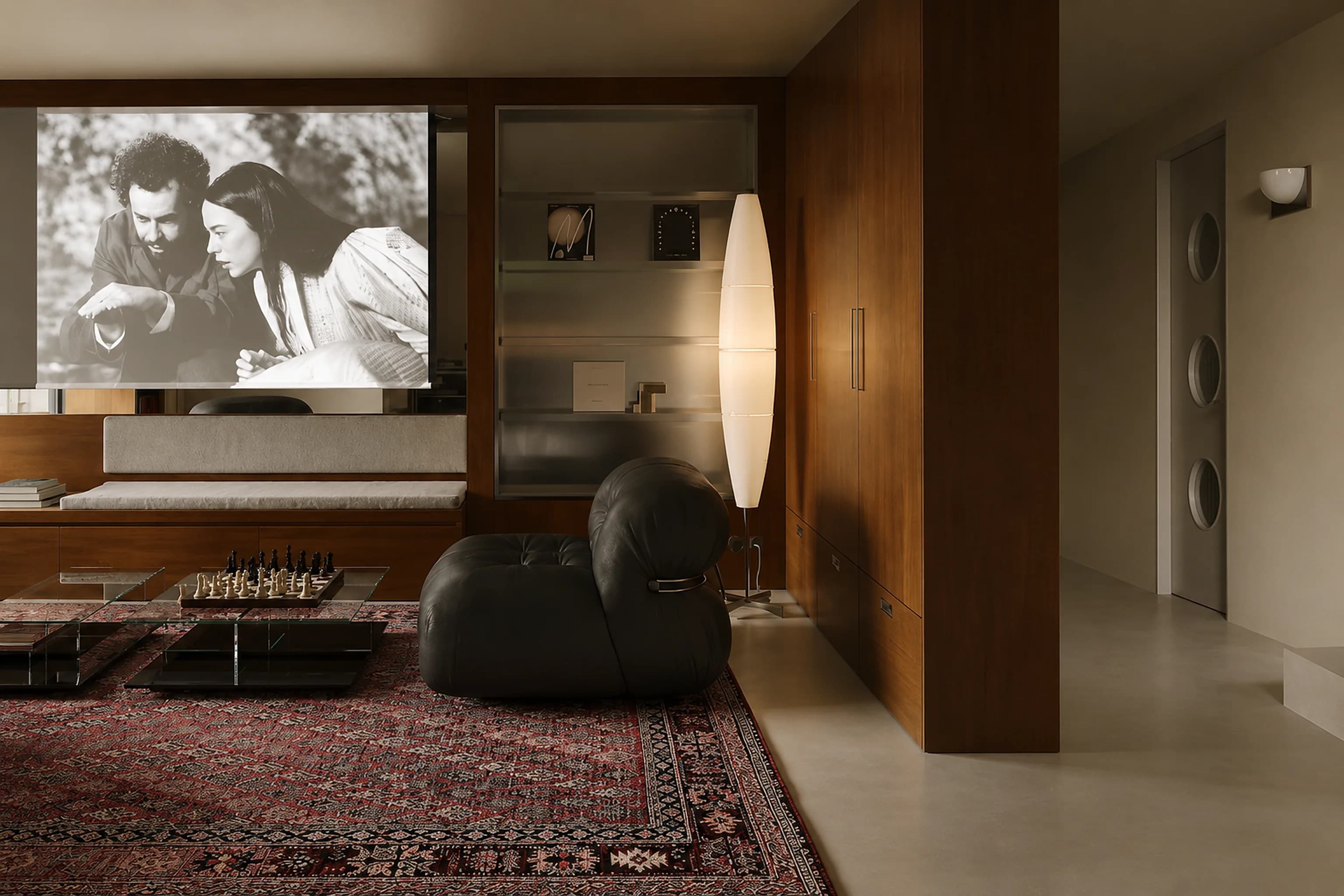A living room with walnut panelling, a dark leather pouf and a Persian rug